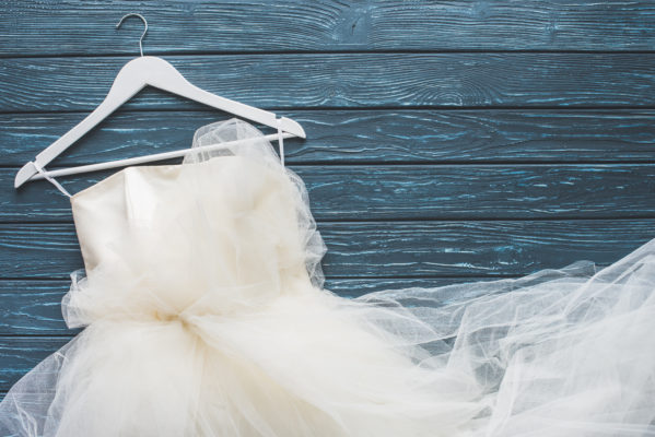 wedding dress on white wooden hanger