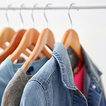 jackets hanging on wooden hangers