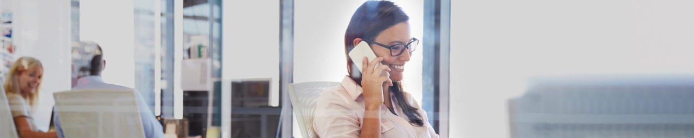 women speaking on the phone in an office